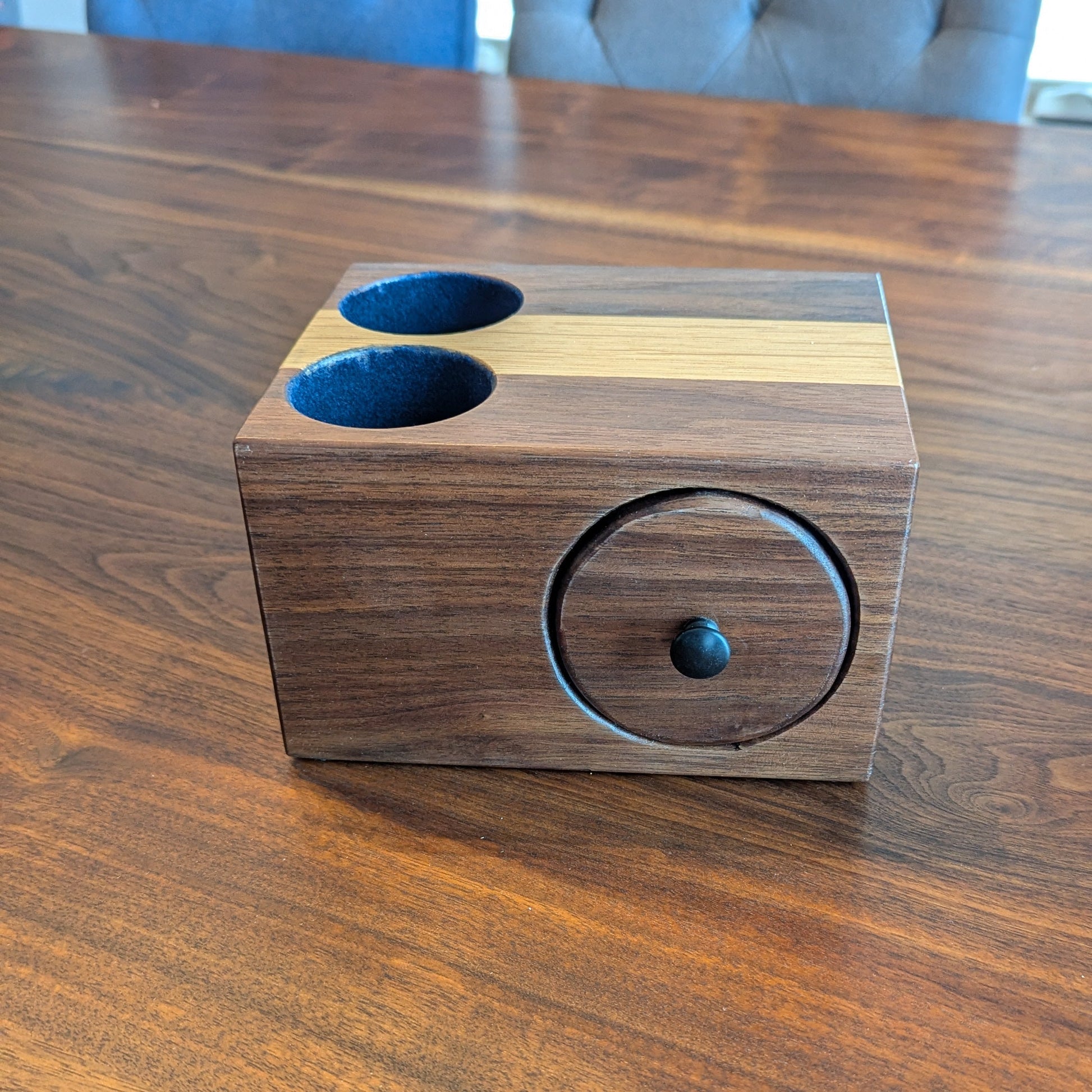 Wooden container with two blue compartments on a wooden surface