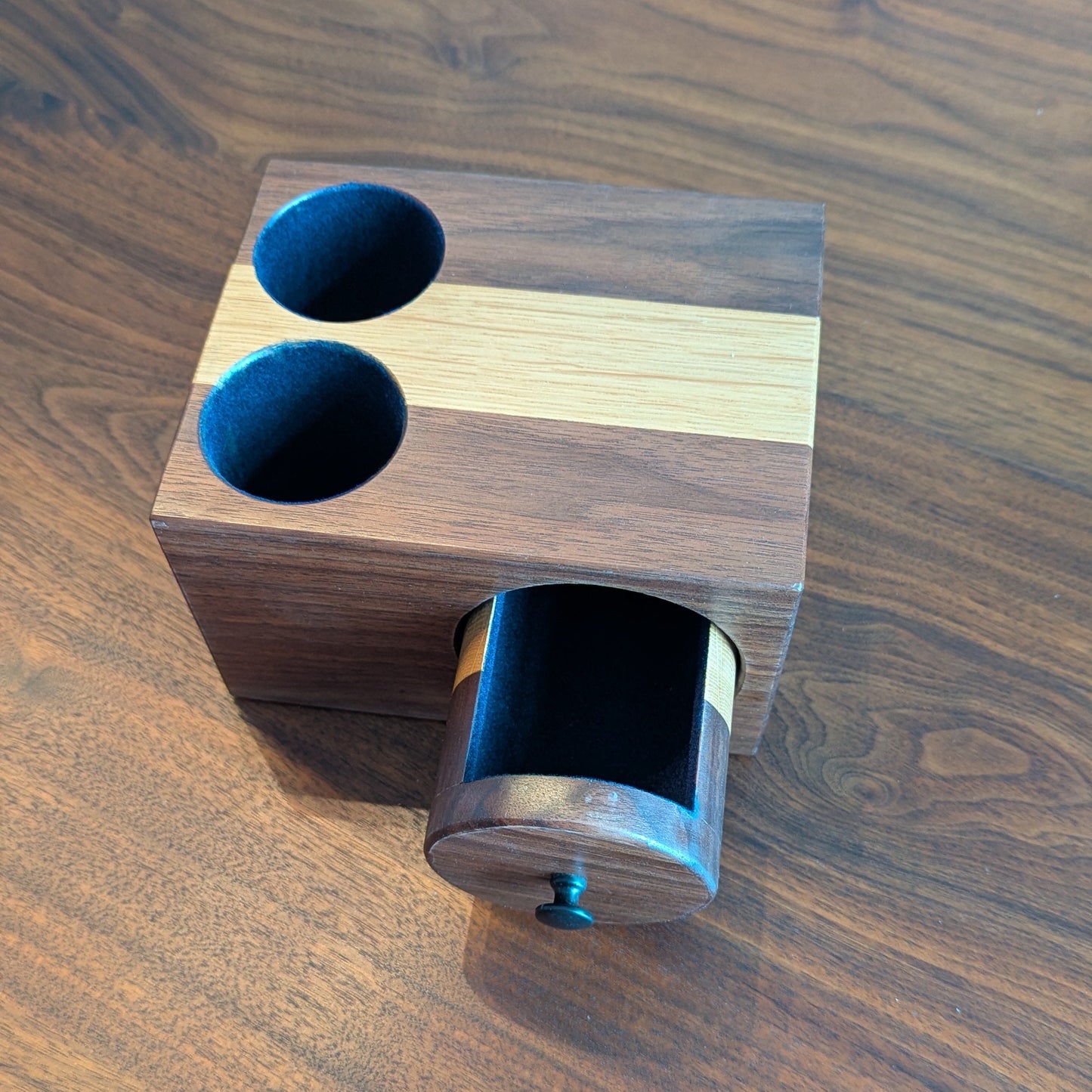 Wooden block with cylindrical indentation on a wooden surface